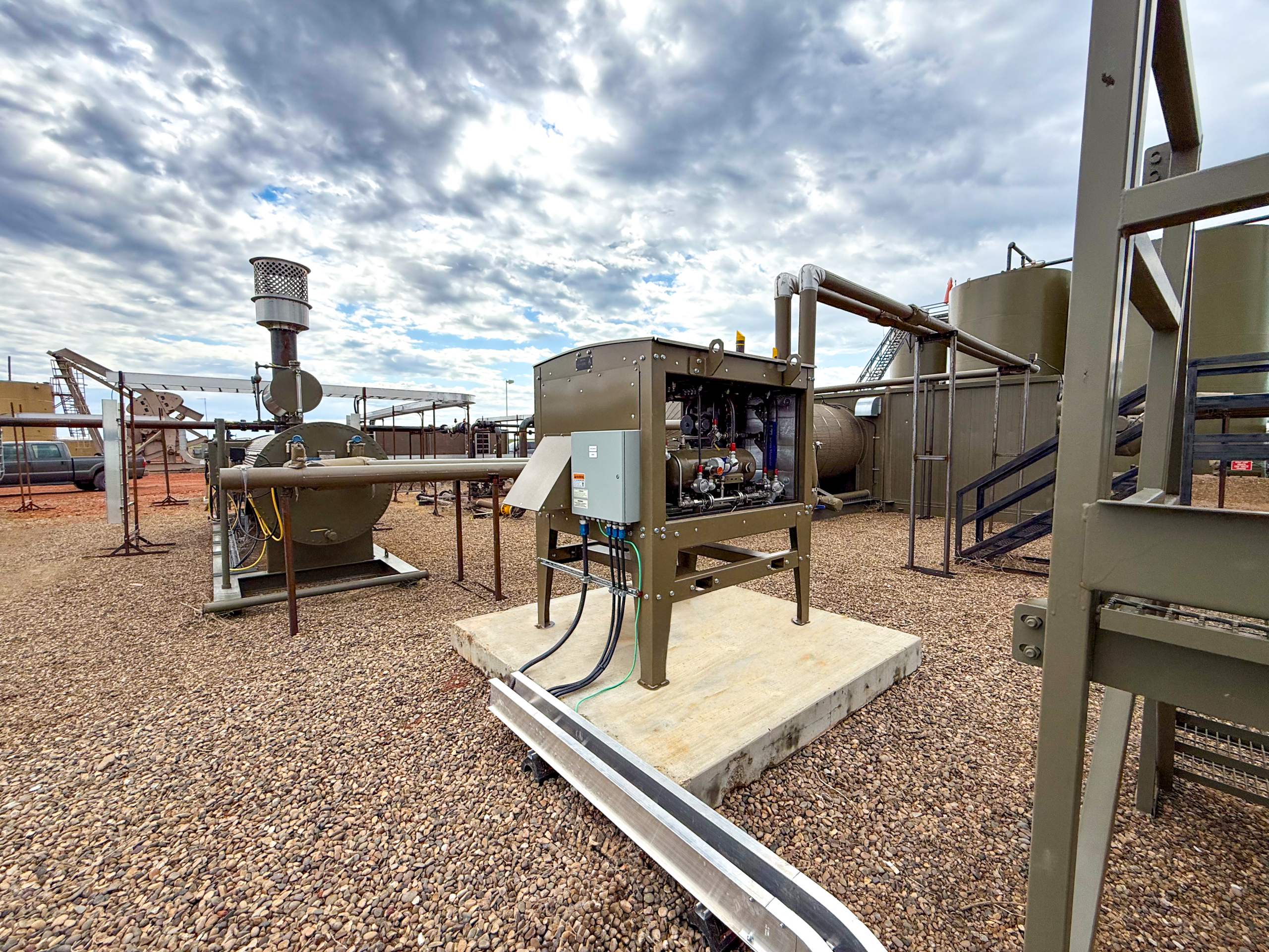 An Emissions Reduction Unit stands on and oil site, continuously operating with oil field systems