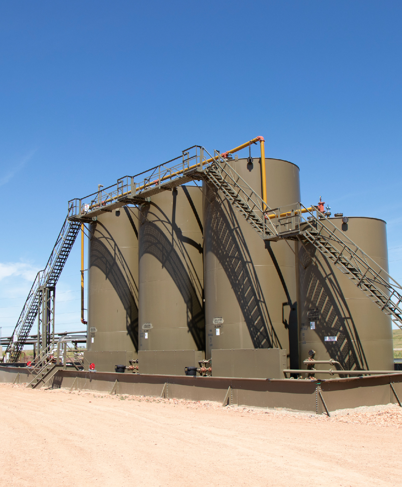 Steffes post-less containment surrounds barrel on an oil site, protecting it in demanding environments.